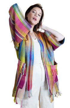 A plaid pattern with a rainbow hue distinguishes a layerable cardigan complete with fringed trims and roomy front pockets. 34" length Shawl collar Long sleeves 60% wool, 40% cotton Hand wash, line dry
 Imported Model stats: 5'10" height, 32" bust, 25" waist, 36" hip. Casual Multicolor Fringe Outerwear, Casual Multicolor Fringed Outerwear, Multicolor Fringe Winter Outerwear, Plaid Cotton Cardigan For Spring, Rainbow Plaid, Cotton Cardigan, Wool Plaid, Shawl Collar, A Rainbow