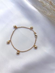 "Solid 14k gold bracelet with hanging puffed hearts. The bracelet length is 6'\" The hearts measure 5.4mm x 4.8mm This bracelet is adorable and sturdy, perfect for babies and toddlers. Bracelet can be lengthened or shortened upon request. All photos are natural and have been taken to the best of our ability. ❤ We guarantee that the item is identical as the actual photo seen. ❤ We Guarantee 100% Pure 14K Gold ❤ Please feel free to message us with any questions you may have ❤ All our Items are als Yellow Gold Charm Bracelet With Dangling Charms, 14k Yellow Gold Charm Bracelet With Dangling Charms, 14k Gold Charm Bracelet With Heart Charm, 14k Gold Yellow Gold Charm Bracelet With Heart Charm, 14k Yellow Gold Charm Bracelet With Heart Charm, Gold Dangle Heart Charm Bracelet, Gold Dangle Charm Bracelet With Heart Charm, Dainty Yellow Gold Charm Bracelet With Heart, Dainty Gold Charm Bracelet With Heart Charm