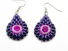 These gorgeous purple and pink teardrop earrings will give you endless compliments! They are reminiscent of peacock feathers. I created them using a bright pink chaton in the center, bezeled using silver and hot pink seed beads. Then I beaded matte deep purple superduos and finished with tiny, sparkly, silver beads. They are hung from hypoallergenic ear wires and come carded with stoppers. Pink Teardrop Beaded Earrings For Party, Handmade Purple Crystal Drop Earrings, Pink Beaded Teardrop Jewelry, Purple Beaded Teardrop Earrings With Ear Wire, Purple Teardrop Beaded Earrings With Ear Wire, Purple Teardrop Beaded Earrings, Pink Teardrop Beaded Earrings, Pink Teardrop Beaded Jewelry, Elegant Pink Teardrop Beaded Earrings