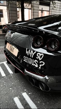 a black and white photo of a car with graffiti on it's hood that says, why so serious?