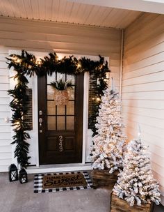 two christmas trees on the front porch