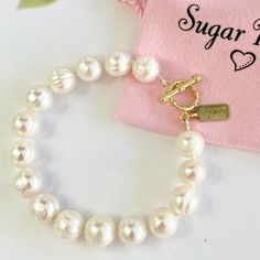 Chunky White Freshwater Pearl Bracelet - Handmade - White Chunky Freshwater Pearls - 14k Gold Filled Toggle And Findings, Sugar Pearls Tag Is 14k Gold Plated - Hand Knotted On White Silk - Bracelet Diameter Is 6-3/8". See Last Photo For Sizing. Matching Necklace And Other Styles And Colors Are Available Non-Smoking, Pet Free Environment Tags & Other Listings: Red Garnet, Iolite, Blue Turquoise, Pink Turquoise, Green Turquoise, Yellow Citrine, Pink Tourmaline, Green Peridot, Quartz, Semi-Precious Hypoallergenic Pearl Bracelet For Anniversary, White Jewelry With Toggle Clasp, Elegant Bracelets With Toggle Clasp And Round Beads, Elegant Bracelets With Clasp, Elegant White Pearl Bracelet With Lobster Clasp, Elegant Adjustable Bracelet With Toggle Clasp, White Bracelet With Toggle Clasp As Gift, Elegant Jewelry With Toggle Clasp For Anniversary, White Adjustable Bracelets With Toggle Clasp