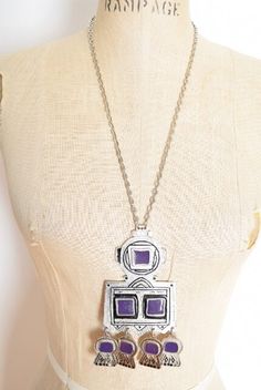 Description:Awesome, huge vintage necklace from the early 90s. It's made of heavy-weight silver-colored metal that has purple and black enameling, and little dangles at the bottom. This necklace comes on a long chain with no clasp.PLEASE NOTE: A little black enamel is missing from one "ear".Label: noneMeasurements:Pendant height incl. dangles: 5.5"Pendant width: 2 5/8"Hips: Total chain length: 25.5" 90s Necklace, Big Pendant, Big Necklace, Necklace Big, Purple Necklace, Enamel Necklaces, Early 90s, Pendant Silver, Long Chain