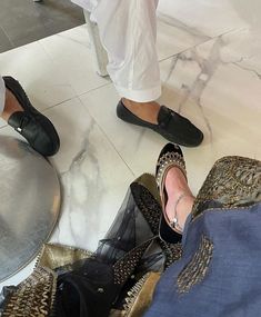 two women's feet in shoes on the floor