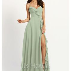 a woman in a long green dress with a slit down the side and one leg