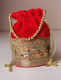 Potli Bag will make you feel incredibly classy in every way! Exquisitely embroidered by hand with glittery metallic threads and genuine semi precious stones. It is certain to bring you compliments. Perfect accessory for Indian wedding! Hand embroidered by third generation master zardozi artisans.  The meticulous embroidery work showcases the artistry and attention to detail put into creating this accessory. Elevate your ensemble with the Elegance Potli Bag - where craftsmanship meets glamour in Luxury Embroidered Handheld Shoulder Bag, Luxury Shoulder Bag Pouch For Gift, Red Embroidered Potli Bag For Party, Luxury Embroidered Festive Bag, Formal Embroidered Handheld Shoulder Bag, Red Embroidered Party Bag, Red Embroidered Party Bags, Luxury Embroidered Potli Bag Clutch, Embroidered Potli Clutch For Evening