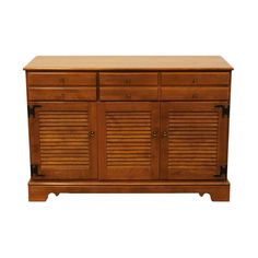 a wooden cabinet with shutters on the doors and drawers in different sizes, shapes and colors