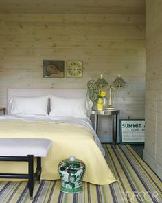 a bed sitting in a bedroom next to a wooden wall