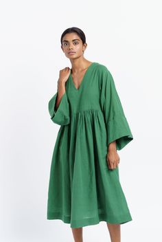 Oversized midi dress in mood elevating basil green color is tailored from handwoven cotton fabric by women artisans of India's western region. Designed for year-round utility, finished with subtle gathers at the waist to give the boxy fit additional contour. This dress would be ideal for transition weather and semi-formal settings. Oversized fit Softy gathered around the waist Roll-up long sleeves V-shaped neckline Dress length: 45 inches Roomy side pockets Lined with soft cotton fabric Model is Dress With A Scarf, Fabric Styling, Western Region, Handwoven Fabric, Necklines For Dresses, Organic Cotton Fabric, Independent Designers Fashion, Dressed Down, Xl Dress