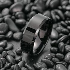 a black ring sitting on top of some rocks