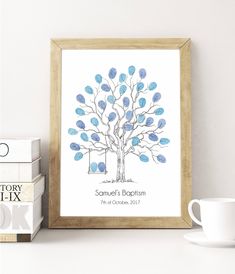 a family tree with blue leaves is displayed in front of two books and a cup