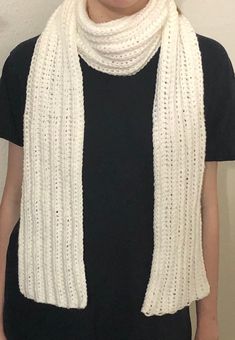 This scarf is made of a soft, acrylic yarn which makes it cozy and easy to care for. It comes in white, black or gray. A matching hat is also available in the shop. Machine washable. Warm Casual Scarf In Acrylic Yarn, Warm Casual Acrylic Yarn Scarf, Casual Acrylic Yarn Scarf, Casual Winter Scarves In Wool, White Knitted Scarf For Fall, Warm Acrylic Yarn Scarves One Size, Cozy White Scarves One Size, Cozy One Size White Scarves, Cozy White Scarves