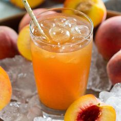 a glass filled with ice next to sliced peaches