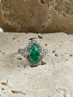 a green ring sitting on top of a rock