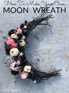 a moon wreath with flowers and stars on it