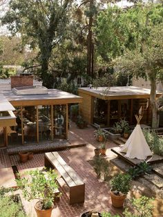 an aerial view of a patio with potted plants and trees in the back ground