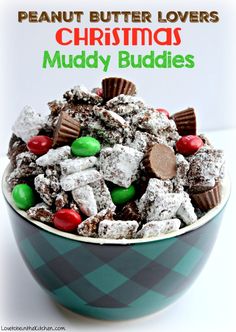 a bowl filled with christmas muddy buddies next to a sign that says peanut butter lovers