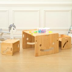 a wooden table with two stools and a horse figurine on the floor