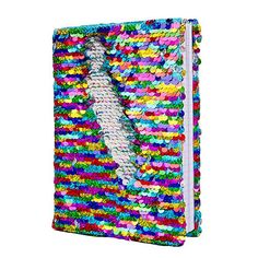 a notebook covered in multicolored sequins