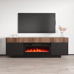 an entertainment center with a fire place and flat screen tv mounted on the wall above it