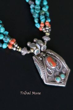 This vintage Tibetan necklace was handcrafted during the late 1900's in the diaspora of Nepal. MEASUREMENTS (1 inch = 2.54 cm): Pendant Size = 2 inches long x 1-1/8 inches wide x 1/4 inch deep Necklace length = 16-1/2 inches Weight = 1.34 oz Shipping weight = 7 oz TM Image Library = 10-7-2017 Its unusual 3-dimensional pendant has real turquoise and red coral beads surrounded by swirling designs. It was made of sturdy 80% silver and does not bend. The back of the pendant was also elaborately deco Vintage Turquoise Necklace With Patina, Traditional Medallion Necklace From Vintage Collection, Traditional Collectible Necklace For Festivals, Antique Beaded Pendant Jewelry, Traditional Medallion Necklace For Collectors, Antique Beaded Pendant Necklace, Traditional Handmade Necklaces For Collectors, Traditional Medallion Jewelry From Vintage Collection, Unique Medallion Necklace From Vintage Collection