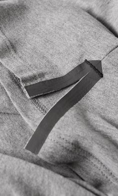 a black and white photo of a piece of cloth with a knife sticking out of it