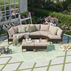 an outdoor living area with furniture and flowers