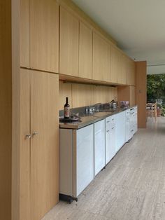 a kitchen with wooden cabinets and stainless steel appliances on the counter top, along with an open floor plan