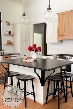 a kitchen with an island and three stools