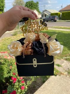 someone is holding up a box with flowers in it and the words happy birthday are cut out