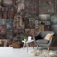 a chair and table in front of a wall with many different colored tiles on it