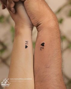 two people with matching tattoos on their arms