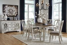 a dining room table with chairs and a chandelier