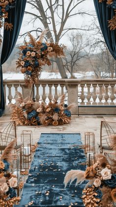 an outdoor ceremony setup with blue and gold decorations