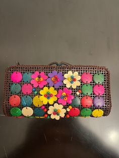 a purse with flowers on it sitting on a table