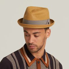 This unlined hat exudes effortless style and sophistication with its minimalist design and quality craftsmanship. Adorned with a 15mm square brown metal badge, it boasts an air of authenticity and refined detail. The grosgrain band adds a touch of elegance to the overall aesthetic, complementing the hat's clean lines. With a 1-inch skimpy turned-up brim, this hat offers a subtle yet stylish look, perfect for sunny days.  Its tear drop crown design adds a classic touch, enhancing its timeless app Classic Solid Fedora For Spring, Modern Adjustable Brimmed Fedora, Modern Fitted Hat With Flat Brim, Modern Fedora With Short Brim For Everyday, Modern Fedora With Adjustable Fit And Short Brim, Modern Adjustable Fedora With Short Brim, Modern Fitted Fedora With Flat Brim, Modern Panama Hat With Short Brim For Spring, Modern Fedora Panama Hat For Spring