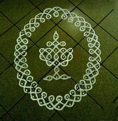 a white circle on the ground with an intricate design drawn in it's center