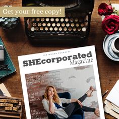 the front cover of she corporation magazine on a desk next to an old typewriter