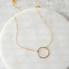 Beautiful 14k gold filled circle necklace that goes with everything. Perfect for everyday wear. Layer it with other gold necklaces or wear it alone. Details: Material: 14k gold filled Length: 16 inches Size: 13mm circle Everyday Hypoallergenic 14k Gold-filled Charm Necklaces, Simple Gold-plated Hypoallergenic Jewelry, Everyday 14k Gold Filled Clavicle Charm Necklace, Simple Hypoallergenic Gold Plated Jewelry, Delicate Round Charm Necklaces In 14k Gold, Everyday Circle Charm Necklaces With Adjustable Chain, Everyday Circular 14k Gold Filled Jewelry, Minimalist 14k Gold Filled Charm Necklaces For Everyday, Minimalist 14k Gold Hypoallergenic Charm Necklace