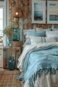 a bed with blue and white comforters in a bedroom next to a wooden wall