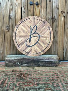 a wooden sign with the letter b on it