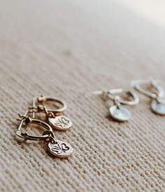 Little details make life special. The “blink and you’ll miss it” aspects of our lives are often the ones that impact us the most. Your most cherished moments and personality traits are what make you beautiful. -10mm hoop earrings -6mm charms -sterling silver or gold filled -choose design for charms (can be two different designs or two of the same) Rose Gold Sterling Silver Huggie Earrings, Huggie Charm Earrings For Anniversary, Charm Huggie Earrings For Anniversary, Huggie Earrings With Charms For Anniversary, 14k Gold Filled Huggie Jewelry With Dangling Charms, Silver 14k Gold Filled Tarnish-resistant Huggie Earrings, Sterling Silver Huggie Earrings With Dangling Charms For Everyday, 14k Gold-filled Silver Huggie Earrings Tarnish Resistant, Dainty Nickel-free Sterling Silver Huggie Earrings