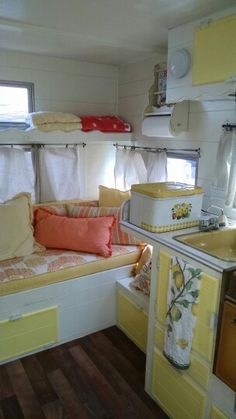 a kitchen with yellow cabinets and white walls