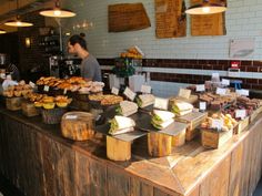 a man standing in front of a counter filled with food