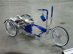 a blue and silver bike sitting on top of a cement floor