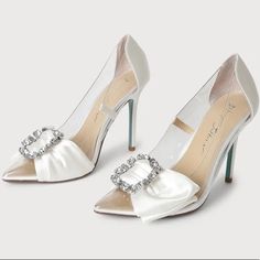 You'll Be Sending Out All The Luxe Vibes When You're Wearing The Betsey Johnson Sb-Moxie Ivory Satin Rhinestone Pointed-Toe Pumps! Clear Vinyl Shapes A Pointed-Toe Upper And A Classic Pump Silhouette, Trimmed With Sleek Woven Satin. A Decorative Bow And Sparkling Rhinestone Buckle Accent The Vamp For A Chic Finish! The Blue Soles Add The Cutest Something Blue To Your Wedding! 4.25" Wrapped Stiletto Heel. Cushioned Insole Rubber Sole Has Nonskid Markings Satin/Lucite Slip On Entry Pointed Toe Shoe Width - Medium Rhinestone Brooch Brand New Never Worn, Changed My Mind Last Minute About My Wedding Shoes And Wore Flats. No Box Or Tags. Perfect Bridal Shoes For An Elegant Bride White Rhinestone Shoe Clips, White Crystal Embellished Shoe Clips For Wedding, Fitted White Wedding Shoes With Rhinestones, White Crystal Embellished Shoe Clips For Formal Occasions, Elegant White Shoe Clips With Rhinestones, Glamorous White Shoe Clips For Wedding, Elegant White Rhinestone Shoe Clips, White Glamorous Wedding Shoe Clips, Glamorous White Wedding Shoe Clips