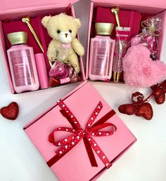 two pink boxes with teddy bears and valentine's day items in them on a table