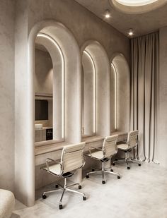 a row of office chairs sitting next to each other in front of arched windowed walls