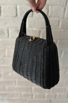 Structured black plastic "wicker" trapezoidal shape handbag with built-in handle, brass top latch clasp, and four brass feet on the bottom. The interior is lined in black plastic fabric with a slide pocket. This bag has a spectacular gloss, a gorgeous design and flawless craftsmanship. Excellent condition Rectangular Straw Bag With Bamboo Handle For Evening, Evening Rectangular Straw Bag With Bamboo Handle, Black Top Handle Straw Bag For Evening, Elegant Evening Straw Bag With Top Carry Handle, Elegant Evening Straw Bag With Top Handle, Chic Black Straw Bag For Evening, Basket Handbag, Black Basket, Plastic Fabric