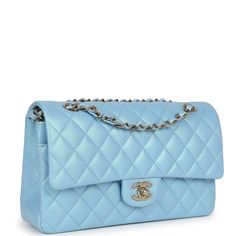 This Medium Classic Double Flap bag is in light blue iridescent calfskin leather with gold tone hardware and features a front flap with signature CC turnlock closure, half moon back pocket, and adjustable interwoven gold tone chain link and light blue leather shoulder strap.The interior is lined in light blue leather with the "love letter" zipper compartment under the first flap, an "outer" slit pocket is under the second flap, and an interior compartment with two open pockets separated by a "lipstick" compartment.Collection: 23AOrigin: FranceCondition: New and never Accompanied by: Chanel Box, Chanel dustbag, felt, ribbon, retail UPC and carebookMeasurements: 10" width x 6" height x 2.75" depth; 16.5" strap drop (9.5" doubled) Luxury Tote Bags, Chanel Box, Travel Handbags, Top Handle Handbags, Trending Handbag, Bag Light, Flap Bag, Blue Bags, Lambskin Leather